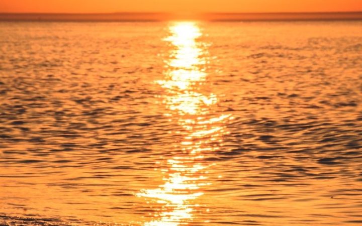 body of water during sunset