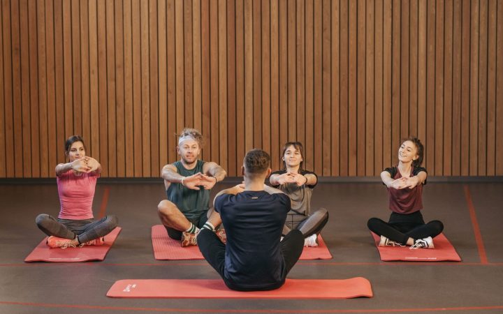 A diverse group practicing yoga in a studio with a focus on wellness and mindfulness.
